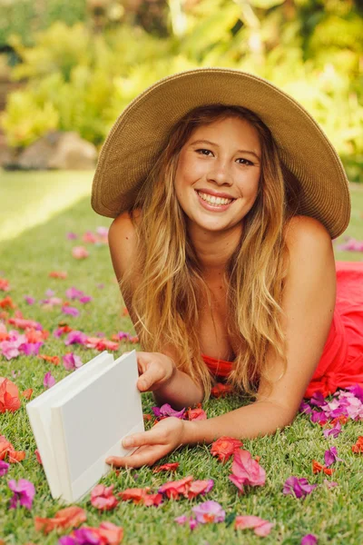 Jovem mulher lendo livro fora — Fotografia de Stock