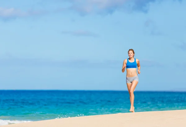 Szép sportos nő fut a strandon — Stock Fotó