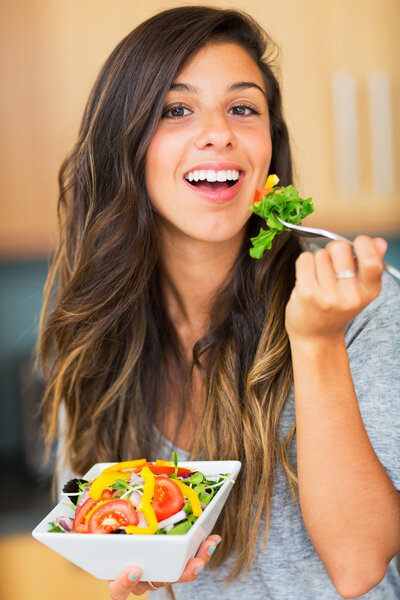 Healthy woman eating salad