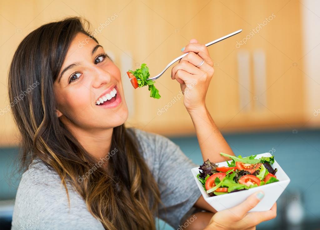 Healthy woman eating salad — Stock Photo © EpicStockMedia 30935897