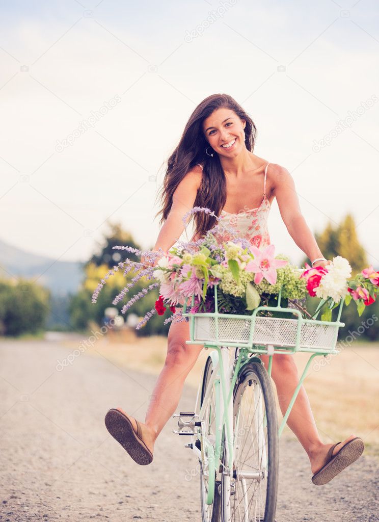Beautiful young woman on bike