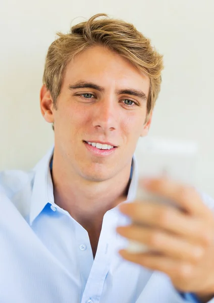Man ser på smart telefon, SMS — Stockfoto