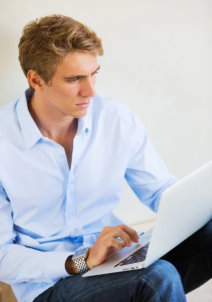 Jongeman werkt op laptop computer thuis — Stockfoto