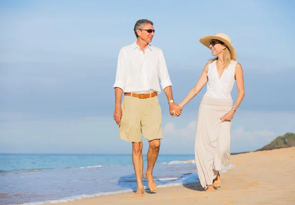 Coppia di mezza età che gode di passeggiata sulla spiaggia — Foto Stock