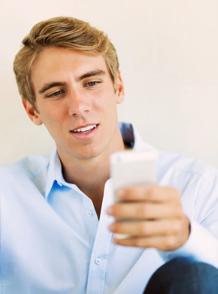 Joven hombre guapo usando el teléfono móvil inteligente , — Foto de Stock