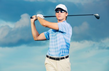 Golf swinging golf club