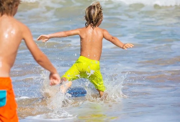 Two young boys having fun on tropcial beach Stock Picture