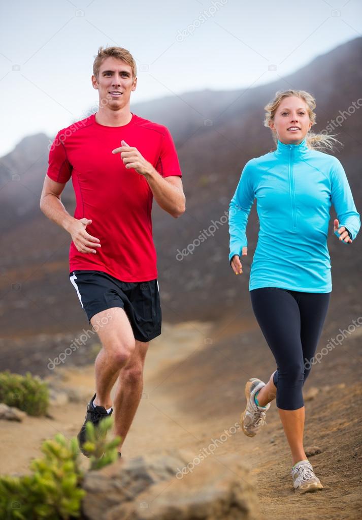 Fitness sport couple running jogging outside on trail