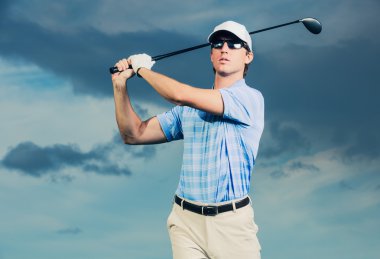 Golf swinging golf club