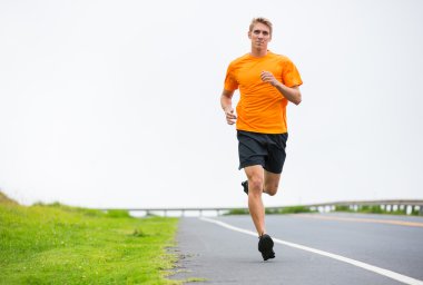 Athletic man running jogging outside