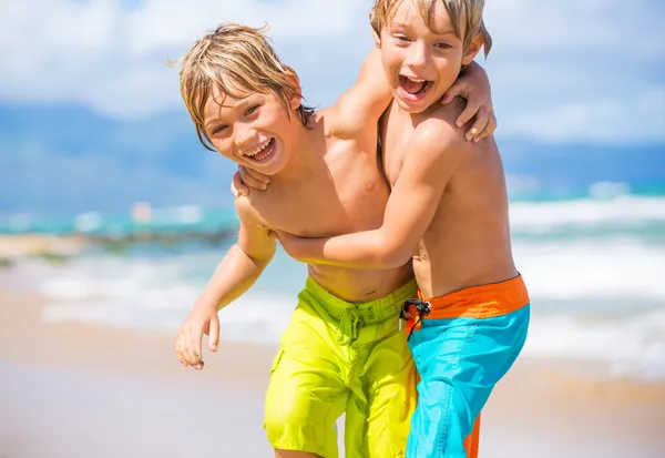 Dois meninos se divertindo na praia tropcial — Fotografia de Stock