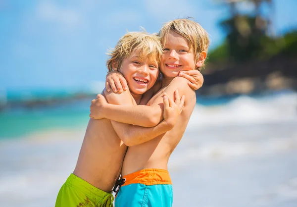 Onnelliset nuoret lapset leikkivät rannalla kesälomalla — kuvapankkivalokuva