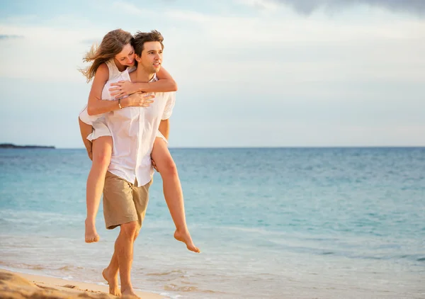 Romantyczny szczęśliwa para na plaży przy zachodzie słońca, mężczyzna i kobieta w l — Zdjęcie stockowe