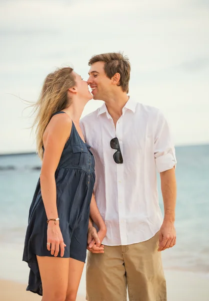 Happy romantic couple kissing on the beach at sunset, Man and wo Stock Picture