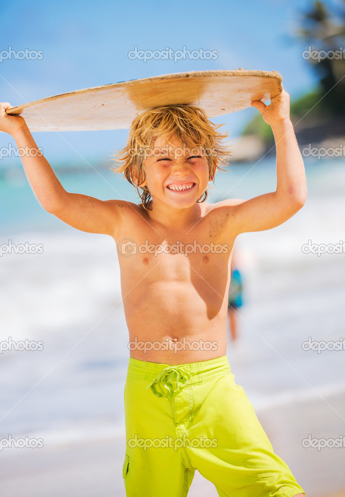 Happy Young boy having fun at the beach on vacation, with skimbo Stock ...