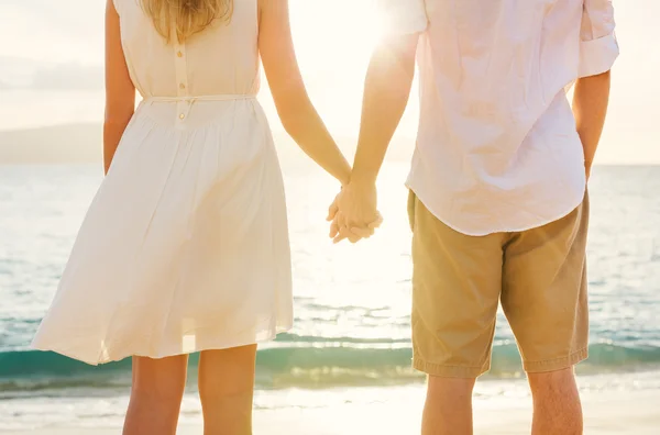 Young couple in love on the beach sunset — Stock Photo, Image
