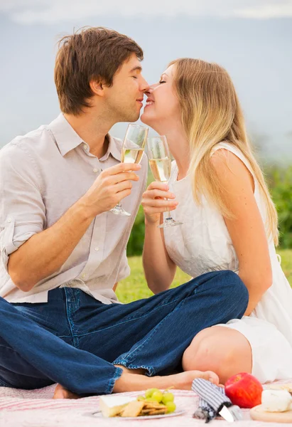 Attractive couple on romantic afternoon picnic kissing — Stock Photo, Image