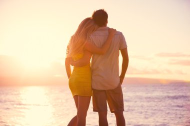 Romantic Couple Watching the Sunset on Tropical Beach clipart
