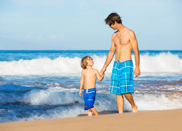 Happy father and son walking together at beach — Stock Photo, Image