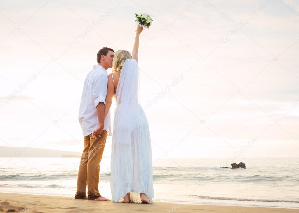 Married couple, bride and groom at sunset on beautiful tropical