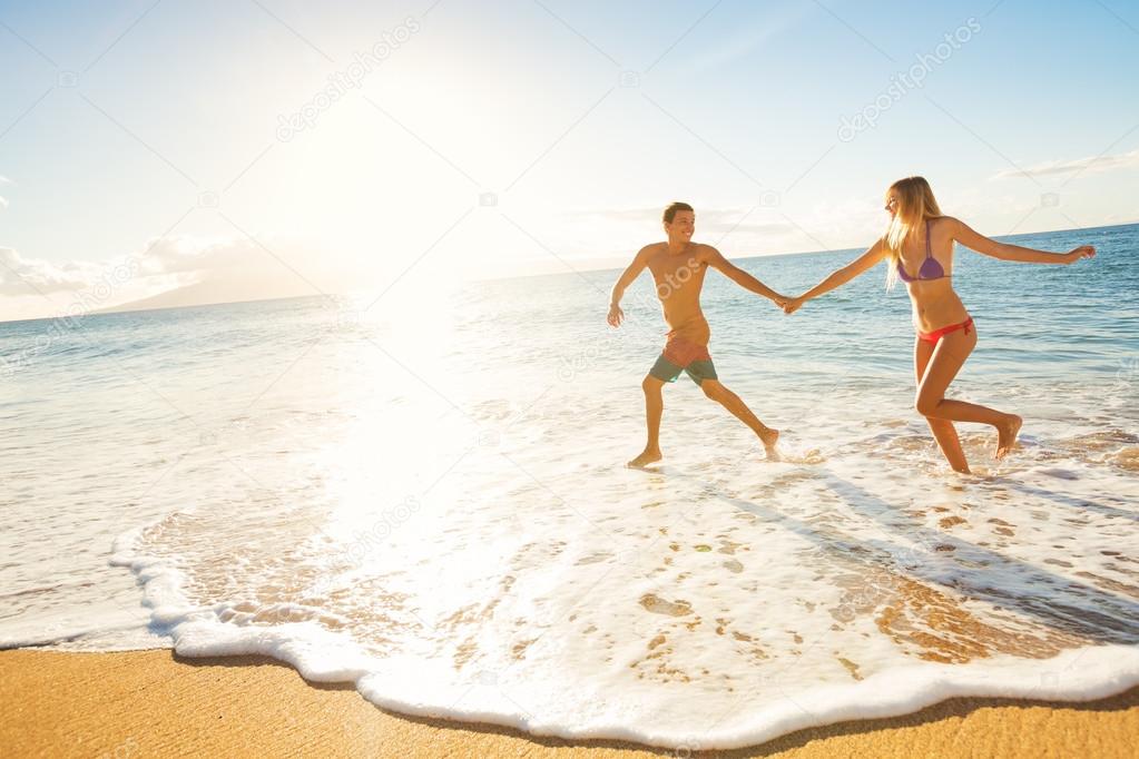 Happy Couple on Tropical Beach at Sunset