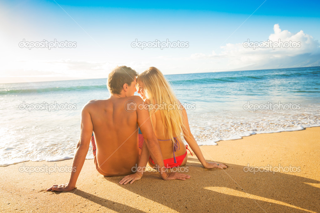 Couple Watching the Sunset on Tropical Beach Vacation