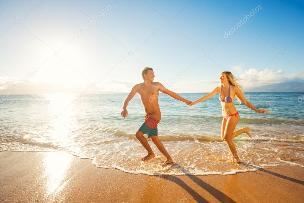 Happy Couple on Tropical Beach at Sunset