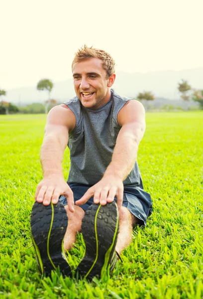 Young man stretching before exercise — Stock Photo, Image