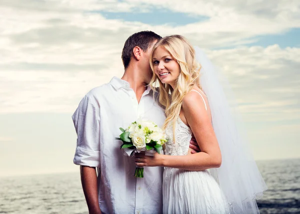 Bride and groom at tropical beach — Stock Photo, Image