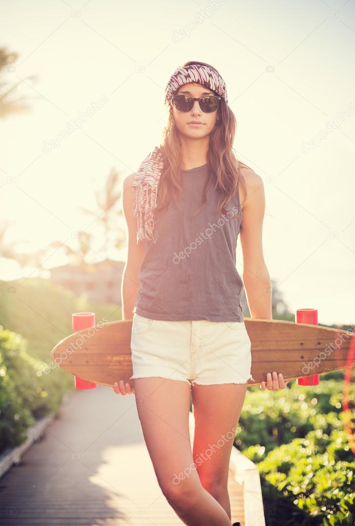 Beautiful young woman with a skateboard