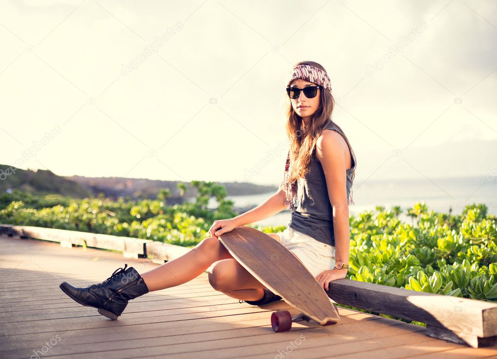 Beautiful young woman with a skateboard