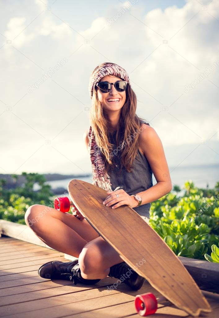 Beautiful young woman with a skateboard