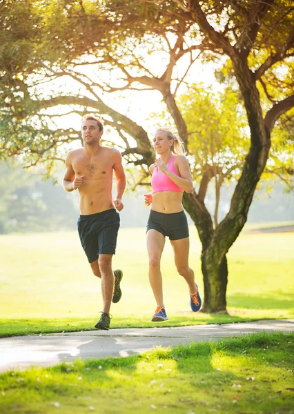 Couple running together in the park — Stock Photo, Image