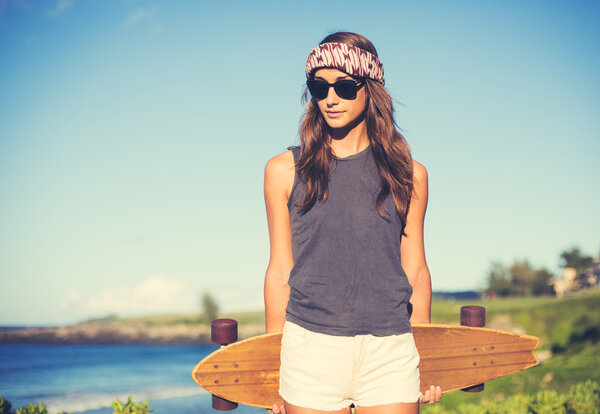 Hipster girl with skate board