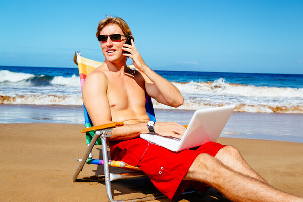 Businessman Relaxing at the Beach with Laptop Computer