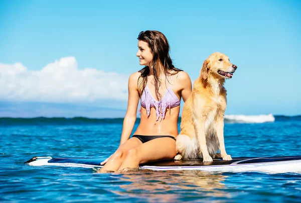 Молода жінка, серфінг зі своїм собакою — стокове фото