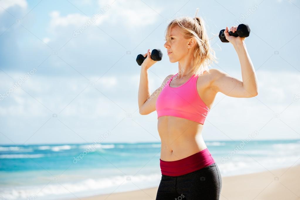 Fitness woman with barbells working out