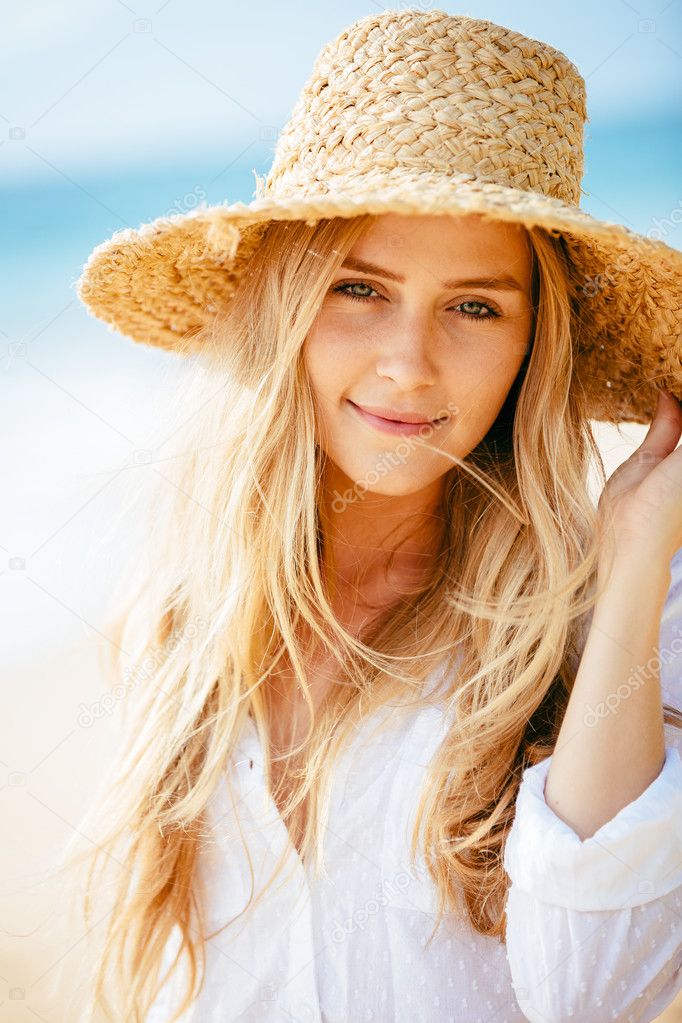 Portrait of beautiful blond girl on the beach