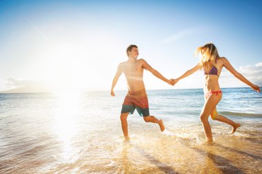 Happy couple on a tropical beach clipart