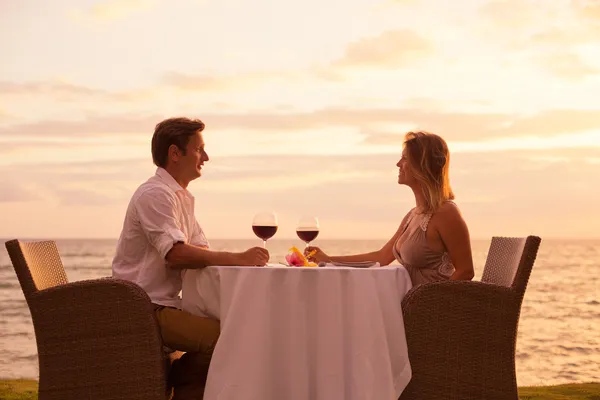 Pareja disfrutando de una cena romántica al atardecer — Foto de Stock