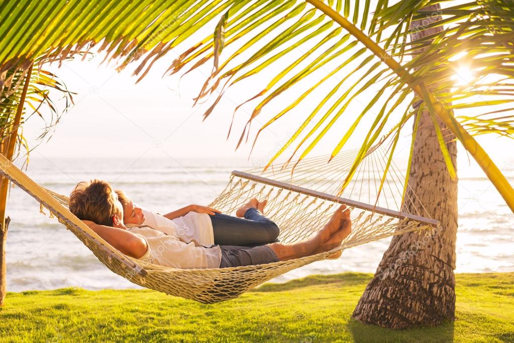 Couple relaxing in tropical hammock