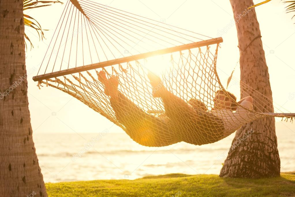 Couple relaxing in tropical hammock