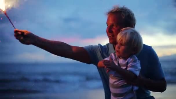 Father and son lighting fireworks — Stock Video