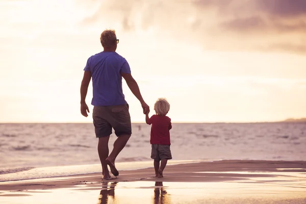 Père et fils murant sur la plage — Photo