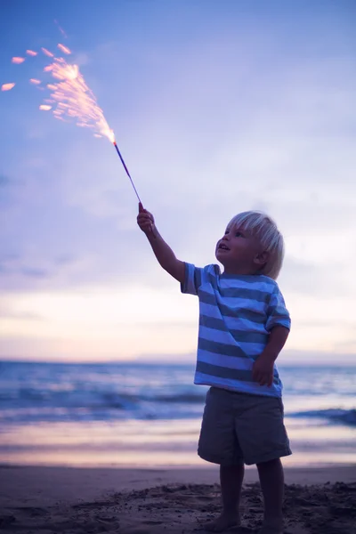 Young boy lighting sparkler — Stock Photo, Image