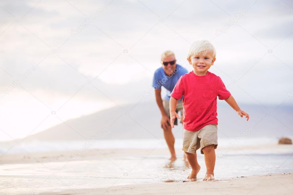 Father and son wallking on the beach