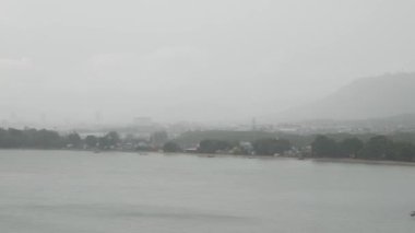 Phuket town from aerial view while raining from the sea bay. Tropical weather