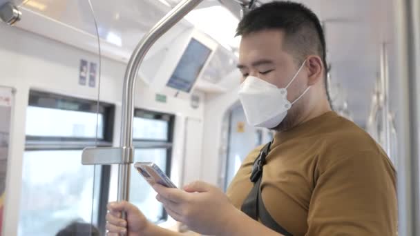 Asian Man Using Smartphone While Public Subway Transportation — стоковое видео