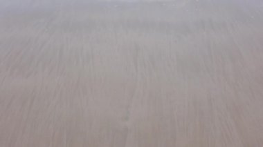 slowmotion of natural sea wave water with foam on the sandy beauty white beach, summer beach seascape