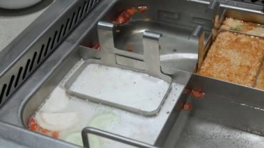 put raw shrimp ball into hot boil spicy soup.szechuan chinese hotpot syle